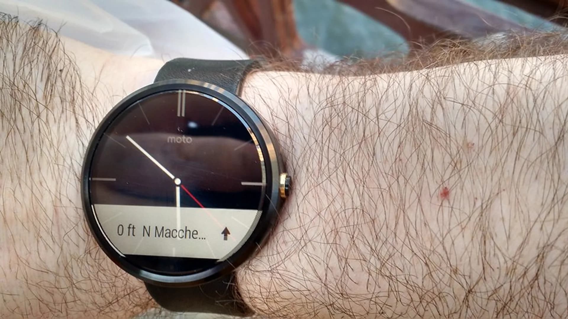Apple Watch Series 10 with a large rounded OLED display worn on a wrist showing the watch face