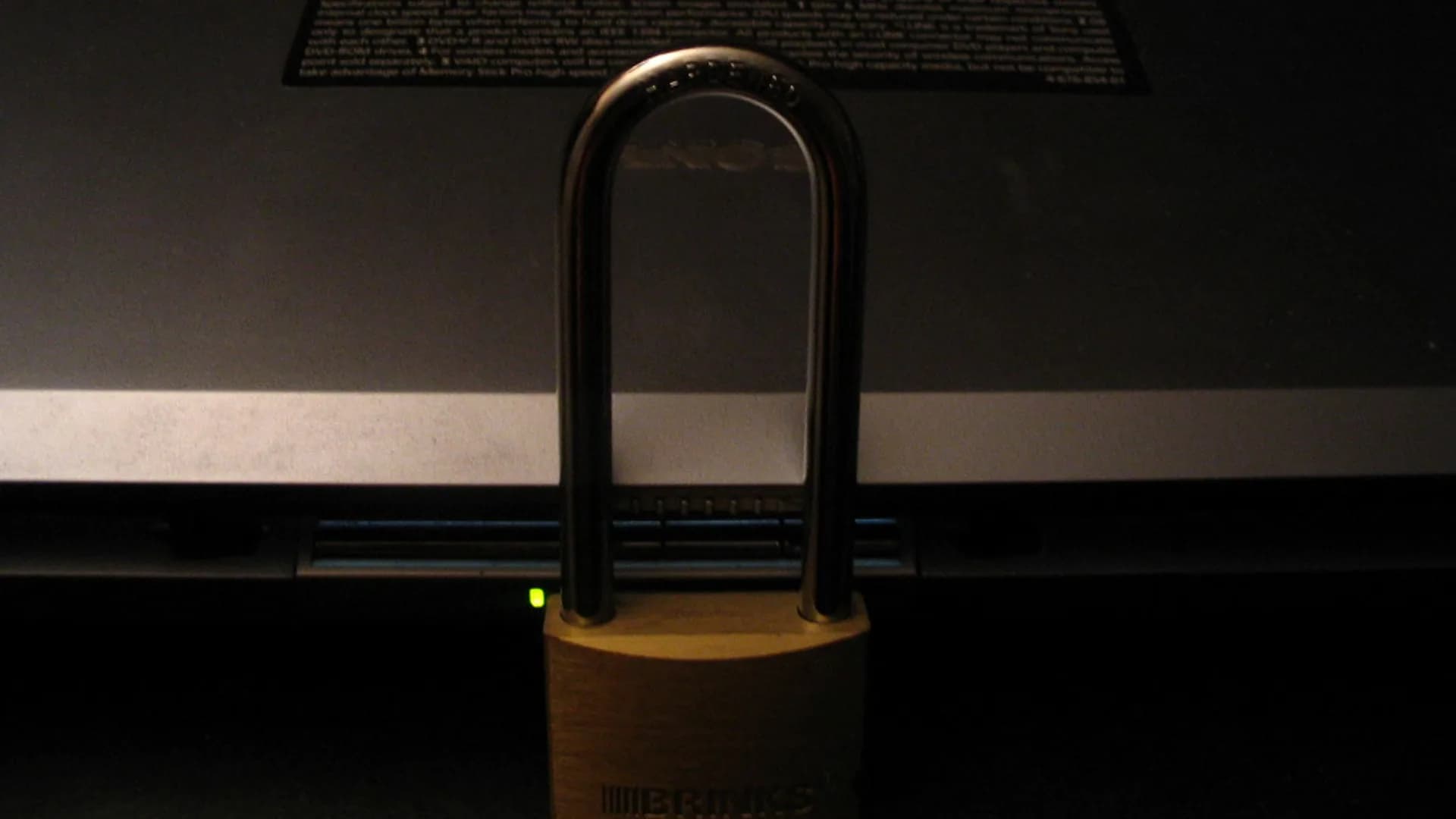A Windows 11 laptop on a desk showing a security shield, representing built-in Microsoft Defender antivirus protection.