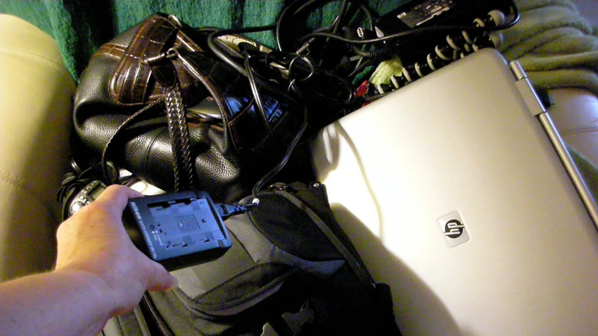 Person holding a smartphone displaying a system software update screen with a download progress bar