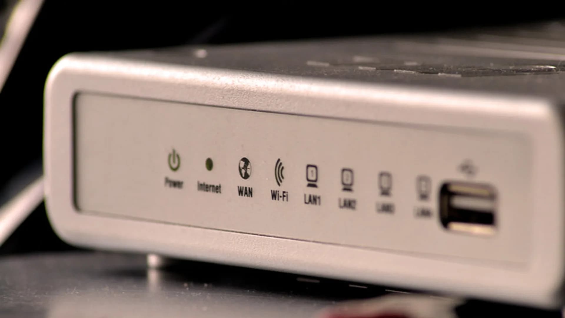 Modern Wi-Fi 7 mesh router with multiple antennas on a desk in a bright home office